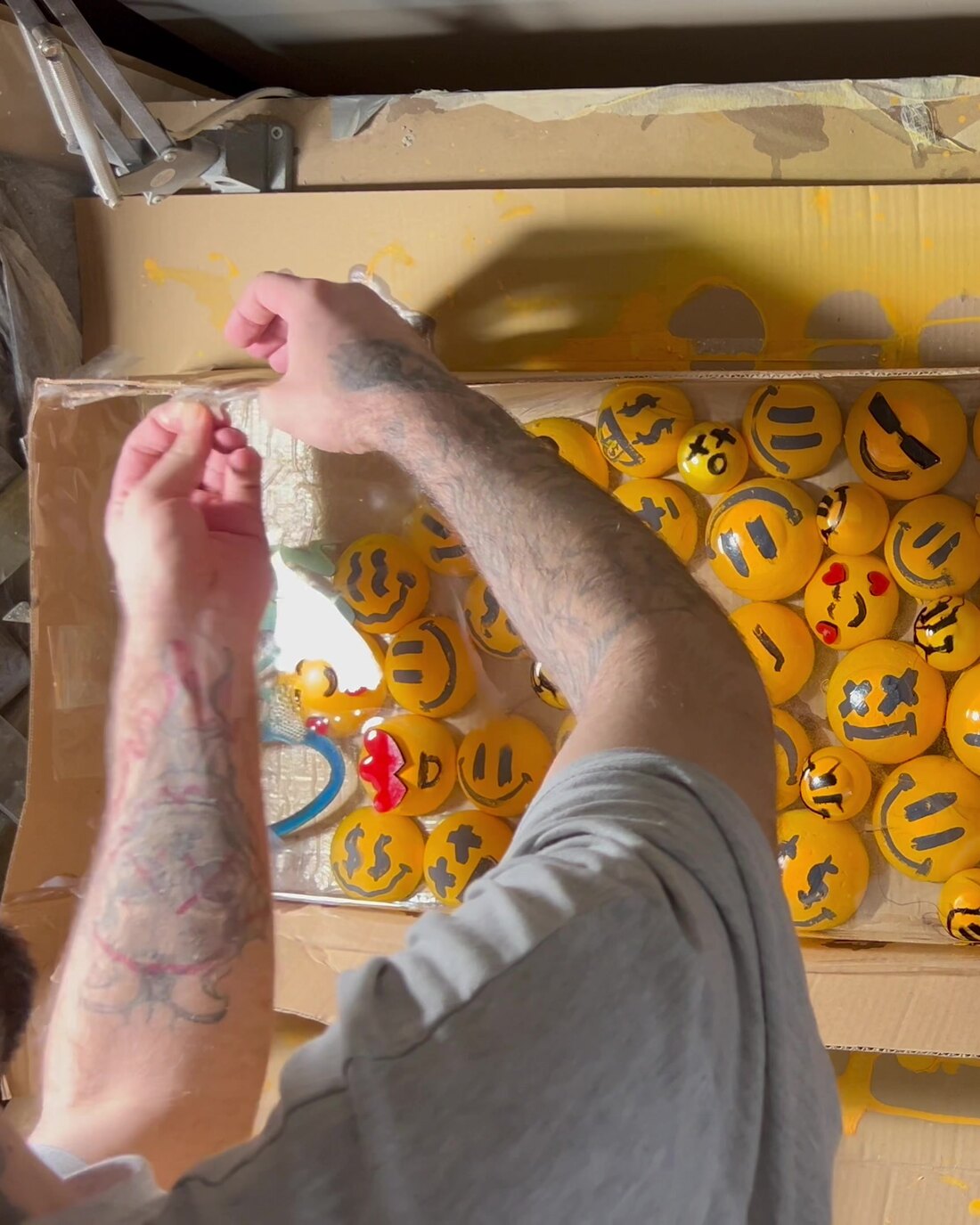 Ozan Kıran at work on an emoji mosaic